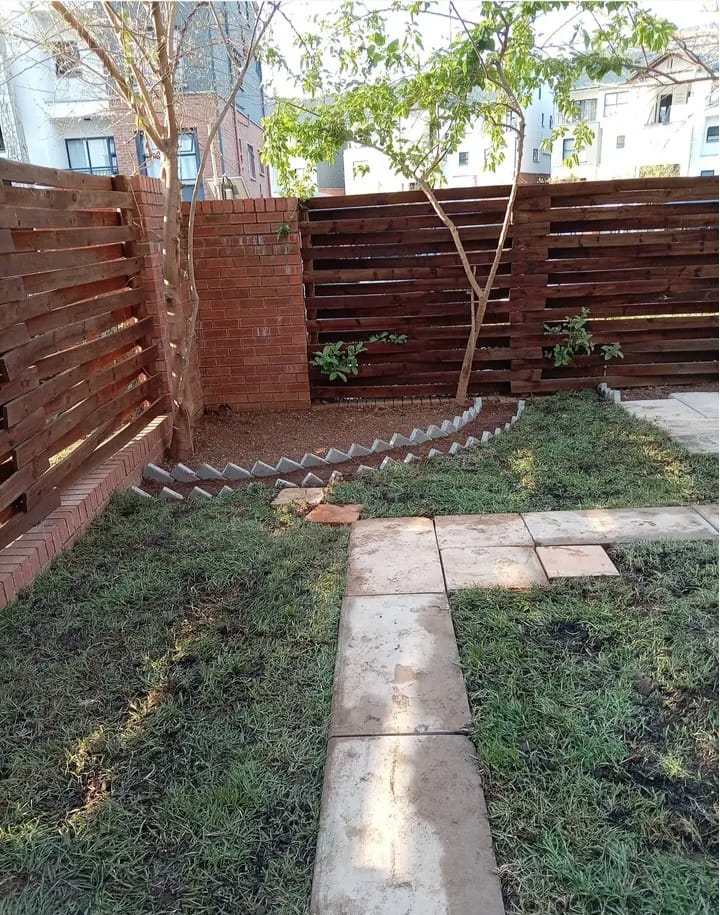 Landscaped garden border with paving and lawn
